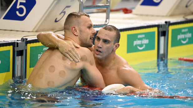 Good mates Kyle Chalmers embraces Zac Incerti following the 100m freestyle at the Olympic trials.