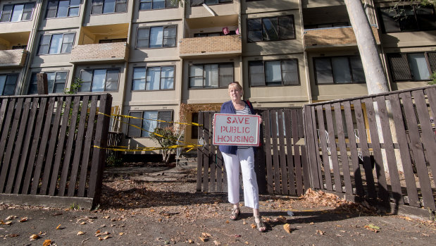 Eileen Artmann in front of the public housing estate where she has lived for 41 years. She does not want to go, and says the deal the government has cut with a developer is not in residents' best interests.