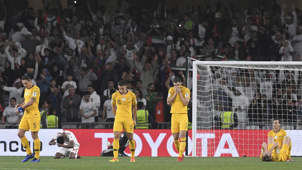 Picture of devastation: Socceroos players confront the grim reality of their 1-0 defeat to the UAE.
