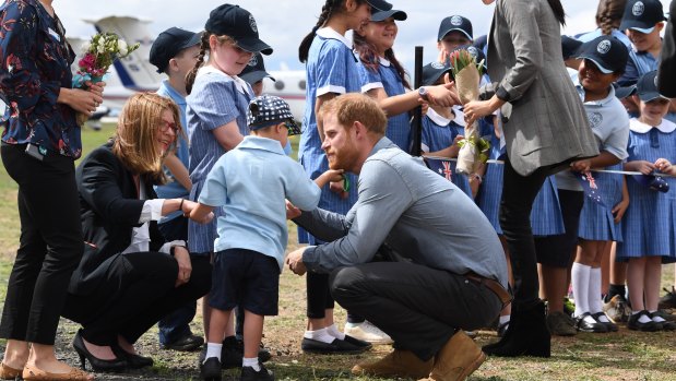 Prince Harry, the Duke of Sussex has his beard tickled by school student Luke Vincent of Buninyong Public School.