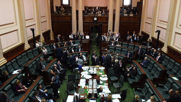 Victorian members of parliament move across the floor of the lower house as an amendment on the the Victoria voluntary assisted dying bill is passed.