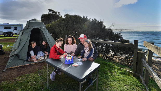 How\'s that for a view? Rosie Smith (left) and Scarlett Hocking slept in a tent, while Scarlett\'s sister Abbey, mother Kate, father Troy and sister Alice stayed in a caravan. Their site at Barwon Head Caravan Park overlooked the beach.  