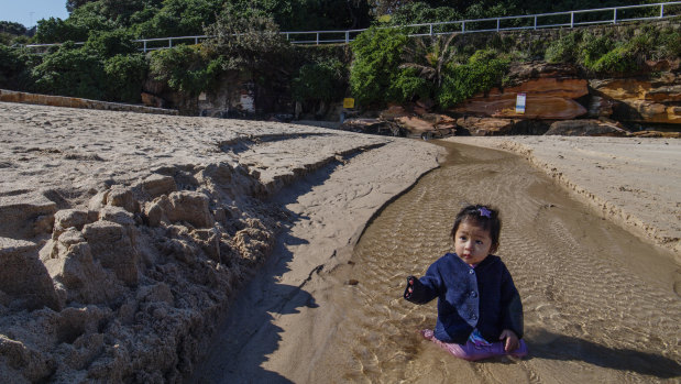 Anthem Mai, 1, playing where the storm water drain runs onto the north end of Coogee Beach.