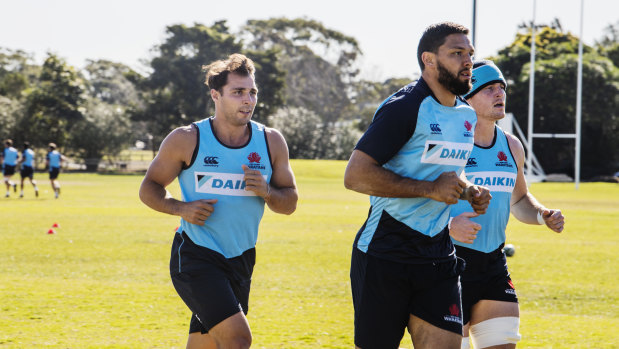 Nick Phipps (left), Curtis Rona and Jack Dempsey warm up at Waratahs training in Sydney on Tuesday. 