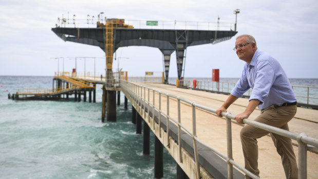 Prime Minister Scott Morrison poses for photographs on the Christmas Island jetty.