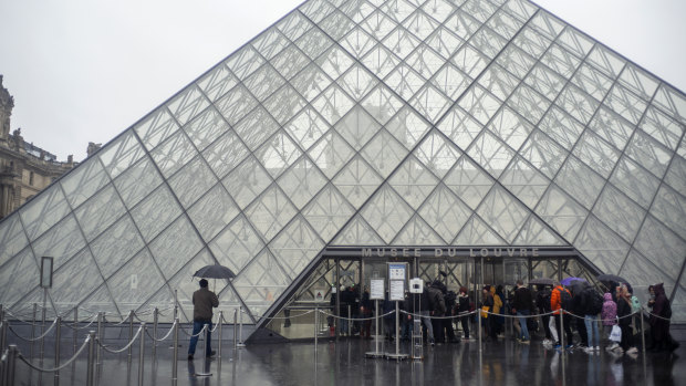 Tourists arrive at the Louvre in Paris to find it closed due to the coronavirus outbreak.