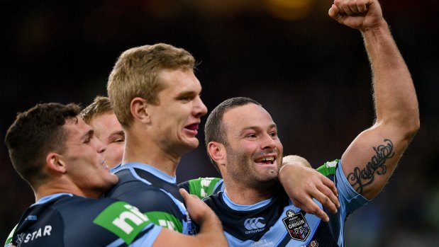 NSW captain Boyd Cordner, right, celebrates their first try with Tom Trbojevic and Nathan Cleary. 