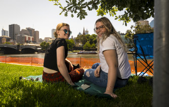 Down from the Gold Coast: friends Rachel Must (left) and Kiarna Broomhead staked out a fireworks viewing spot near the Princes Bridge, with a view of Melbourne's skyline.
