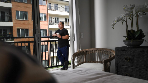 Aged care worker Joeben Roxas picture on the balcony of his on-site apartment.