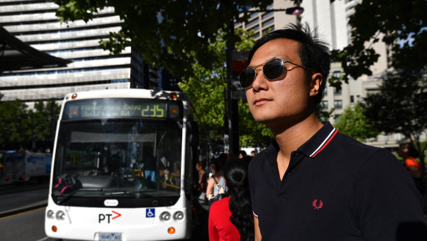 Passengers board the 235 while Toby Chan waits for the delayed 232 bus outside Southern Cross station.