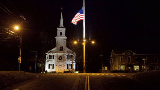 A US flag flies at half-mast on Main St in honour of the 26 students and staff killed in a mass shooting at the Sandy Hook Elementary school in Newtown, Connecticut in 2012.