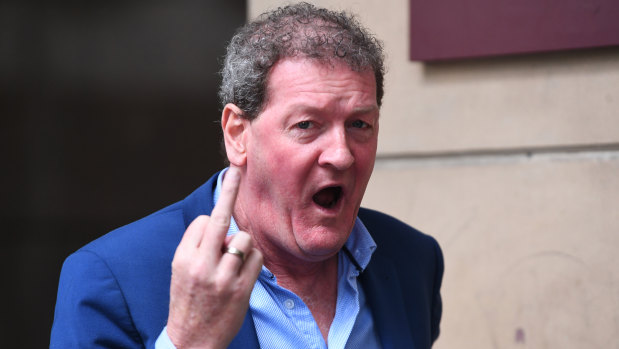 Ricky Nixon gestures as he arrivies at the Melbourne Magistrates Court on Thursday.