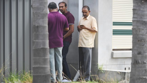 Friends and family of Dr Reddy took calls as they gathered outside her home.