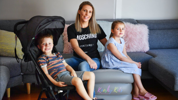 Louisa Williams with her children Mila and Jack and some of the baby equipment she shares through sharing platform Kindershare.