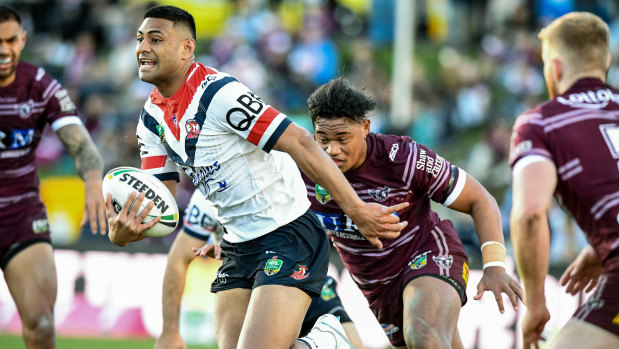 Rampant: Daniel Tupou busts through the Manly defence at Lottoland.