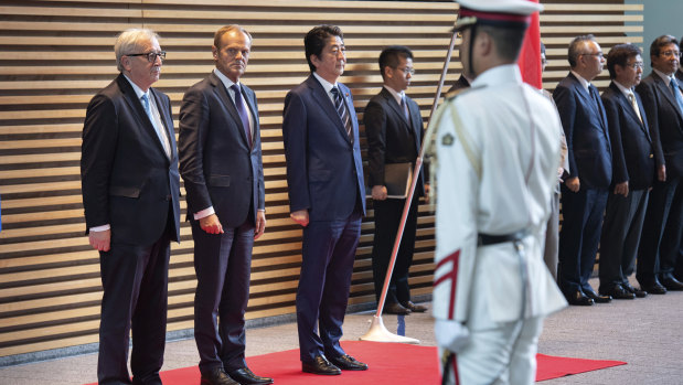 From left: European Commission President Jean-Claude Juncker, Donald Tusk and Shinzo Abe at a welcome ceremony in Tokyo on Tuesday.