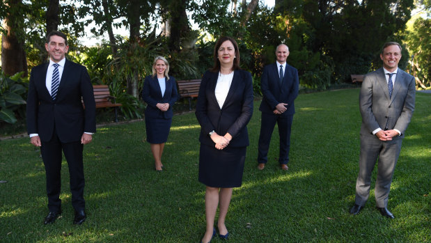 Premier Annastacia Palaszczuk with new or repurposed members of cabinet at Government House on Monday.