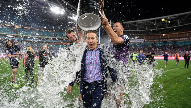 Craig Bellamy gets doused after winning the 2017 grand final.