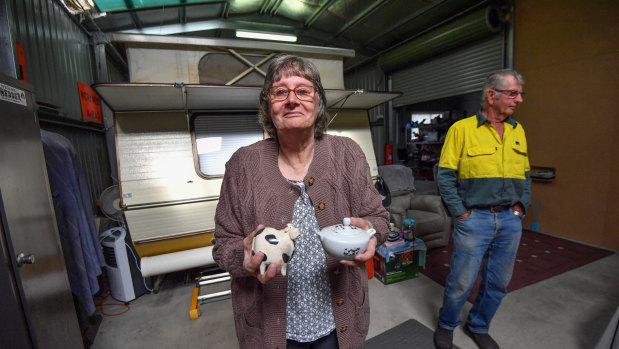 Lyn Wallwork holds items salvaged from the fires. 