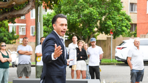 Ray White auctioneer James Hayashi prepares to sell the Randwick unit.