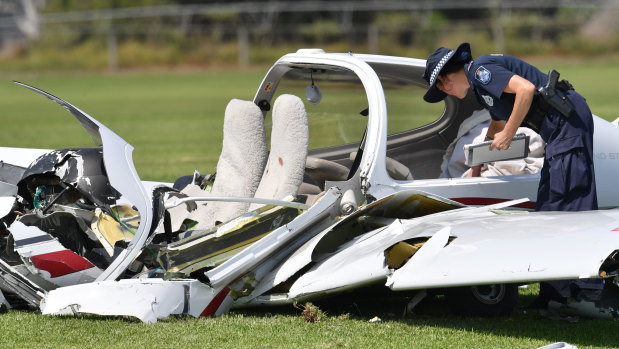 Police look over the wreckage at the scene of the light aircraft crash at Allenview on September 26, 2017.