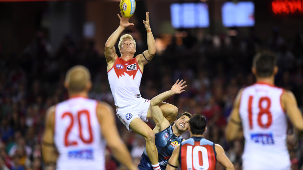 Isaac Heeney climbs high to take a spectacular mark with his first touch of the season. 