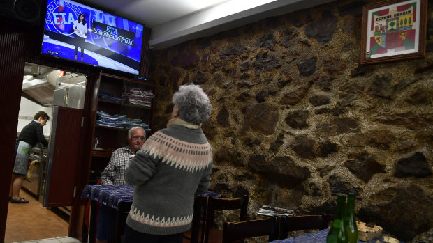 People have lunch in a small bar restaurant as they await the televised last announcement of the Basque armed separatist group ETA, in the small basque village of Hernani, northern Spain.