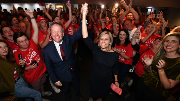 Labor leader Bill Shorten and returned MP Susan Lamb celebrate as they arrive at their election night function in Caboolture, north of Brisbane, on Saturday.