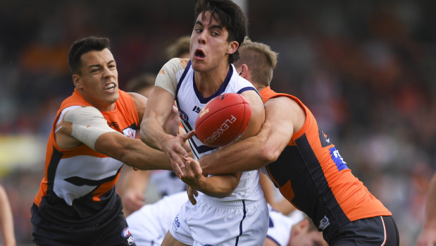 Dockers player Adam Cerra takes on Dylan Shiel of the Giants.