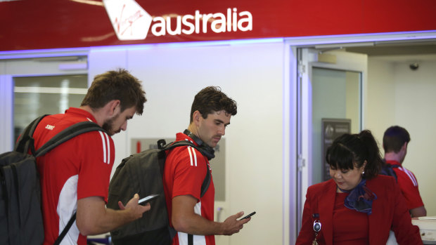 Swans players depart Sydney on a flight to Adelaide on Friday for their first game of the season. 