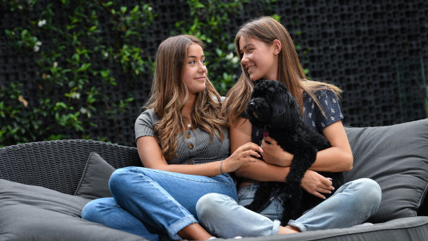 Alex (left) and Charley Cowen, with their dog Billy, will help other kids going through adversity to keep doing "normal" things.