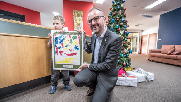 Five-year-old Rowan Blackmore, of Kambah, had the honour of presenting his framed painting to Chief Minister Andrew Barr at the Smith Family Christmas Appeal launch on Friday.