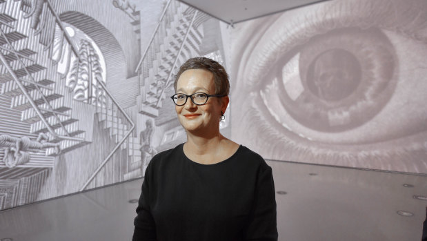NGV senior curator prints and drawings Cathy Leahy with projections of Escher's works.