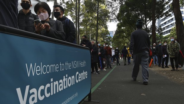 People queue for COVID-19 vaccinations at the NSW Health Vaccination Centre at Olympic Park.