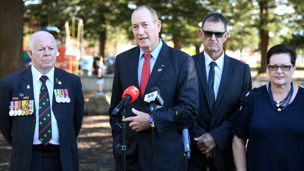 Senator Fraser Anning, centre, is joined by candidate for the seat of Cook Peter Kelly, left, as he speaks to the media at Dunningham Park at Cronulla in Sydney on Friday.