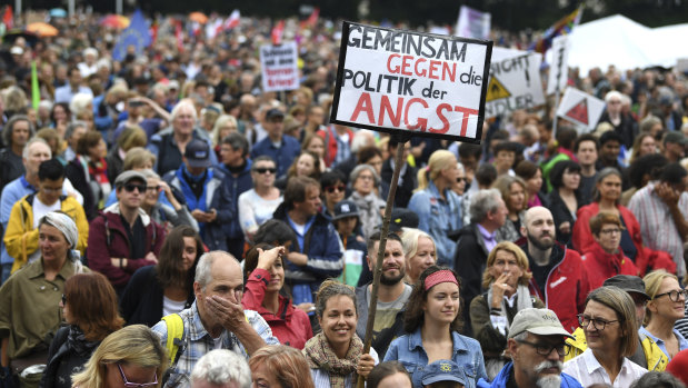 A woman with a poster reading 'United Against The Politics Of Fear' at a demonstration in Munich in July.