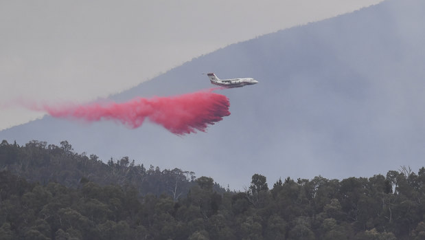 A water bombing airplane is seen dropping fire retardant at the Pierces Creek fire near Canberra in November.