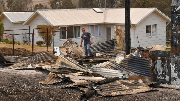 Giovanni Kilman outside his home after fires ravaged his property.