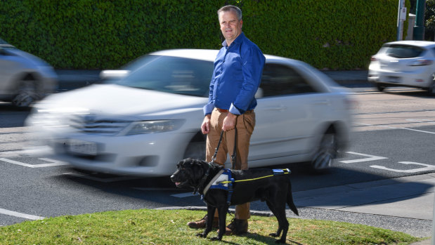 Chris Edwards with his seeing eye dog, Odie.