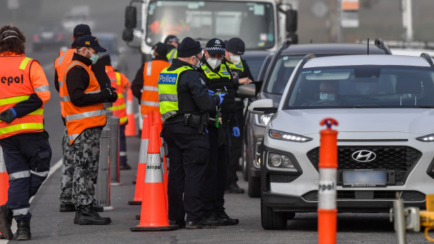 Victorian Police and the ADF Australian defence force man a road block at Coldstream.