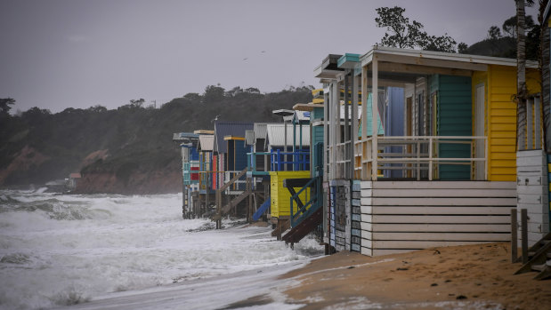 Beach boxes exposed to the sea at Mount Martha North 