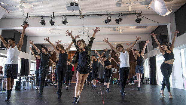 Choreographer Amy Campbell (centre) puts the cast of A Chorus Line through their paces during rehearsals at the East Sydney Community and Arts Centre. 