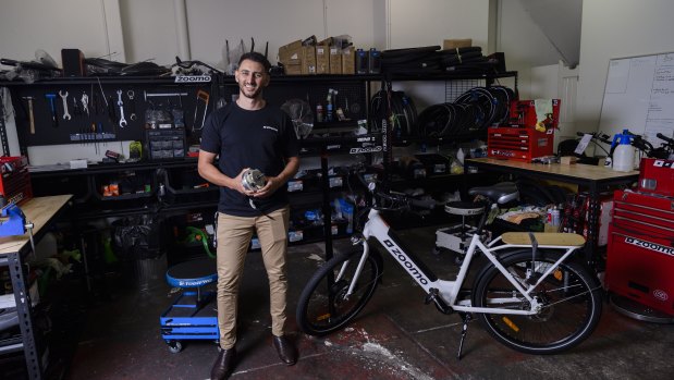 Zoomo chief executive and co-founder Mina Nada holds an engine from one of the company's bikes at its Surry Hills, Sydney, store.