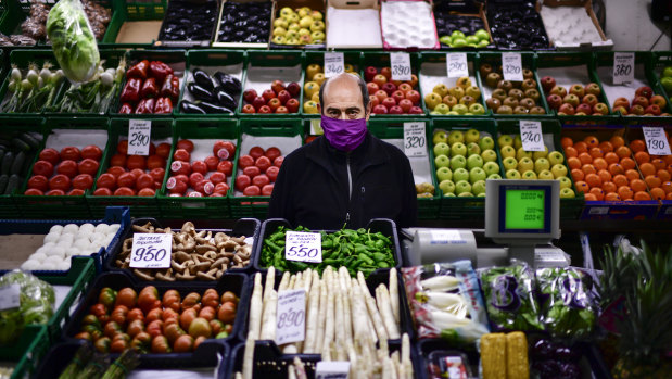 Is four days enough? A man minds his fresh food market stall in Pamplona, northern Spain. 