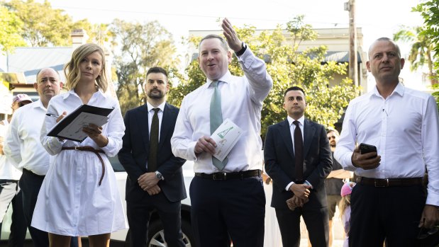 Auctioneer Edward Riley (centre) and selling agent Joseph Tropiano (right) at the auction for the Petersham home.