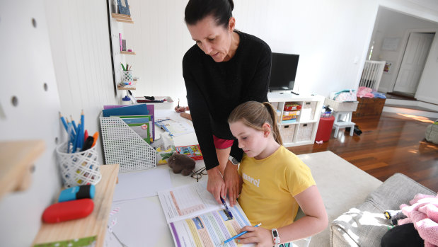 Michelle Merriman helps her daughter Grace, 8, with schoolwork as she learns from home in Brisbane.