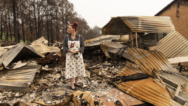Donna Combe, one of Conjola's residents, stands amid the ruins of her home.