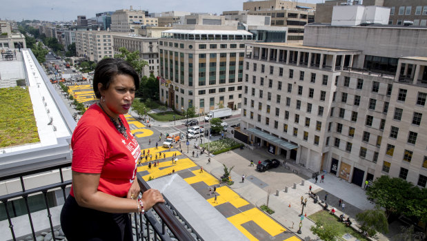 District of Columbia mayor Muriel Bowser stands on the rooftop of the Hay Adams Hotel near the White House and looks out at the words 'Black Lives Matter' that have been painted in bright yellow letters on the street.