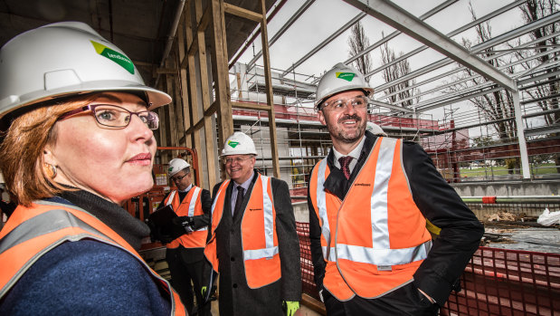 ACT Minister for Higher Education Meegan Fitzharris, vice-chancellor Brian Schmidt (second from left), and Chief Minister Andrew Barr took a tour of the work in progress on Tuesday.