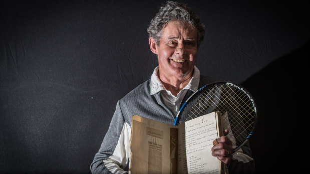 Reid Tennis Club president Terry Walker with the treasured book of minutes that records the very first meeting of the club 90 years ago.